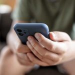 teenager boy is using smartphone at home - home schooling