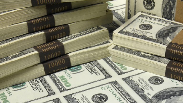 Stacks and sheet of US one hundred dollar bills, elevated view